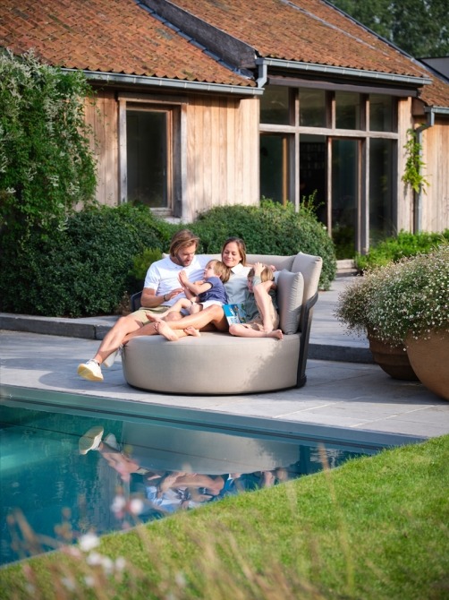 Family in Cielo daybed by the pool
