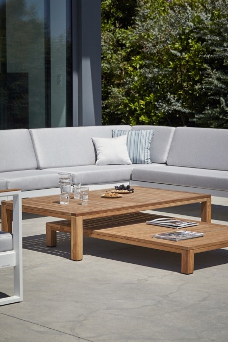 Natural teak coffee tables on terrace next to lounge set