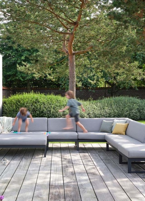 kids jumping in outdoor lounge set - Landscape Teak