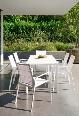 Outdoor dining table with armchairs on terrace