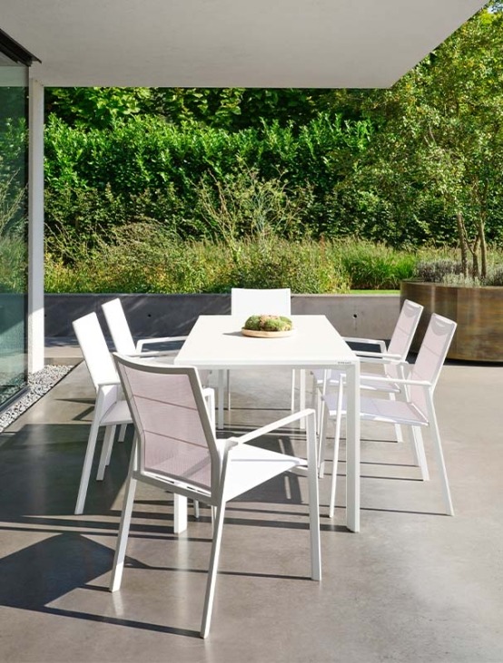Outdoor dining table with armchairs on terrace