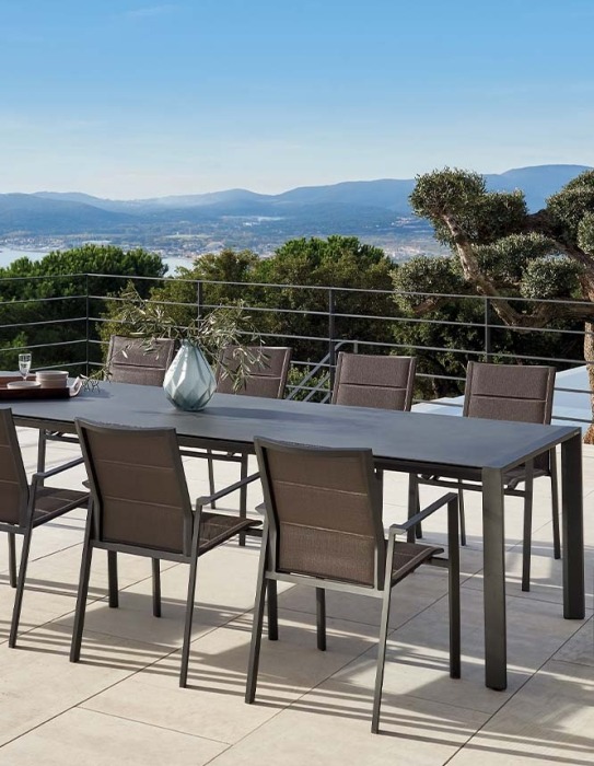 Outdoor dining table on terrace with chairs