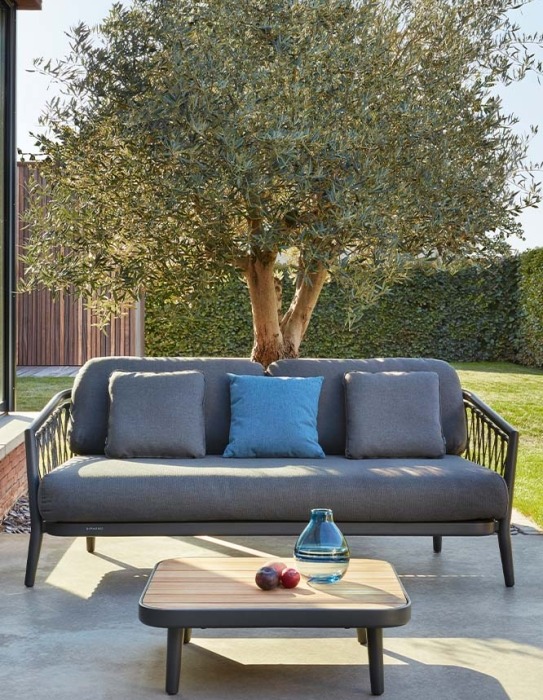 Outdoor sofa with rope on terrace with olive tree