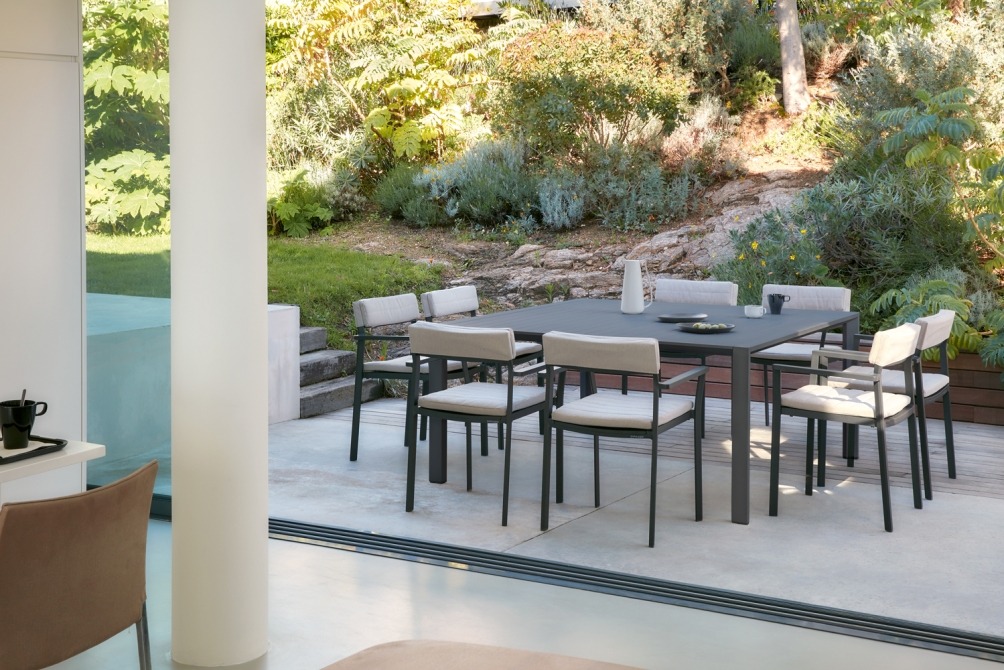 Metris dining armchair at square table on terrace