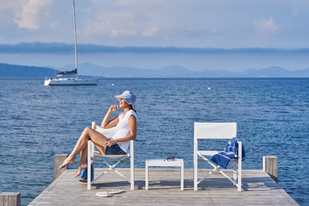 woman in Alexa folding director's chair with sea view