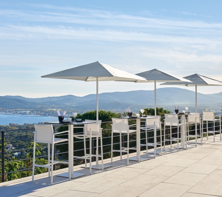 Alexa bistro tables and barstools on terrace with sea view