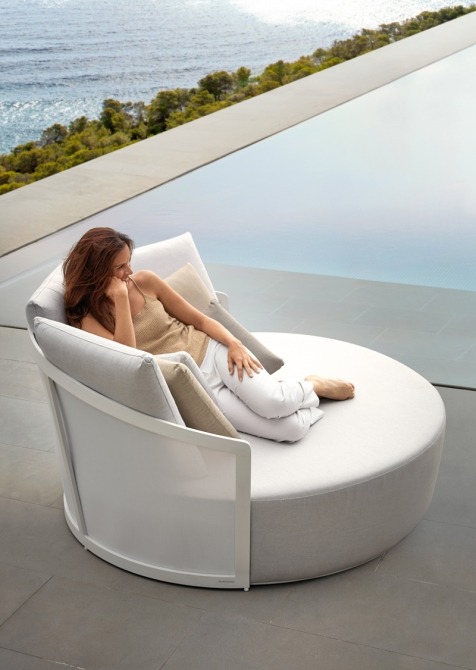 Woman in Cielo daybed by the pool with ocean view