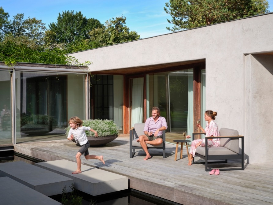Family in modular lounge set Landscape Teak on terrace