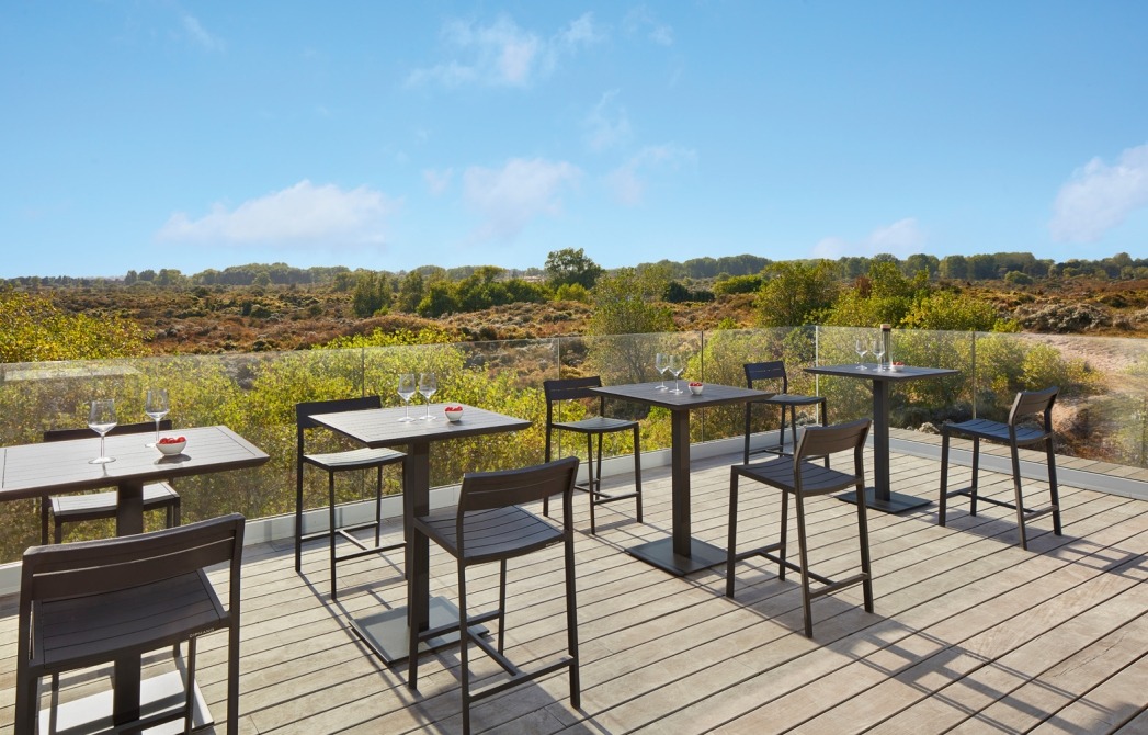 Metris bistro tables and barstools on terrace