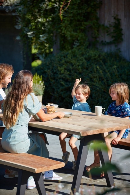 Family having breakfast at pure dining table and bench