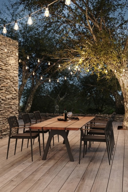 Pure dining table on terrace with cozy lights