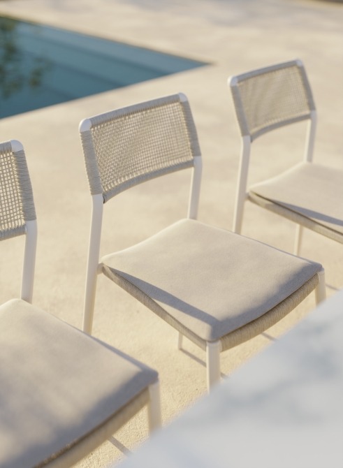 Ray dining side chair with fabric seat cushion on terrace